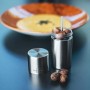 Nutmeg mill with stainless steel grinder with storage compartment for up to 4 nutmegs